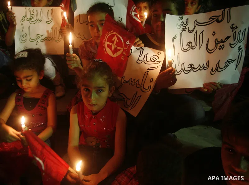Palestinian children light candles, during a rally outside a tent solidarity with prisoners who have been waging a hunger strike in Israeli jails, in Gaza City May 11, 2012. A hunger strike by Palestinian prisoners again...