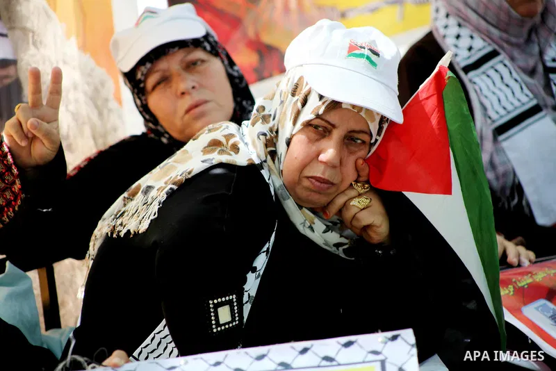 Palestinian women hold pictures of their jailed relatives during a sit-in in Gaza city in support of over 1,550 prisoners observing a hunger strike to demand better conditions in Israeli jails on May 12, 2012. The World...