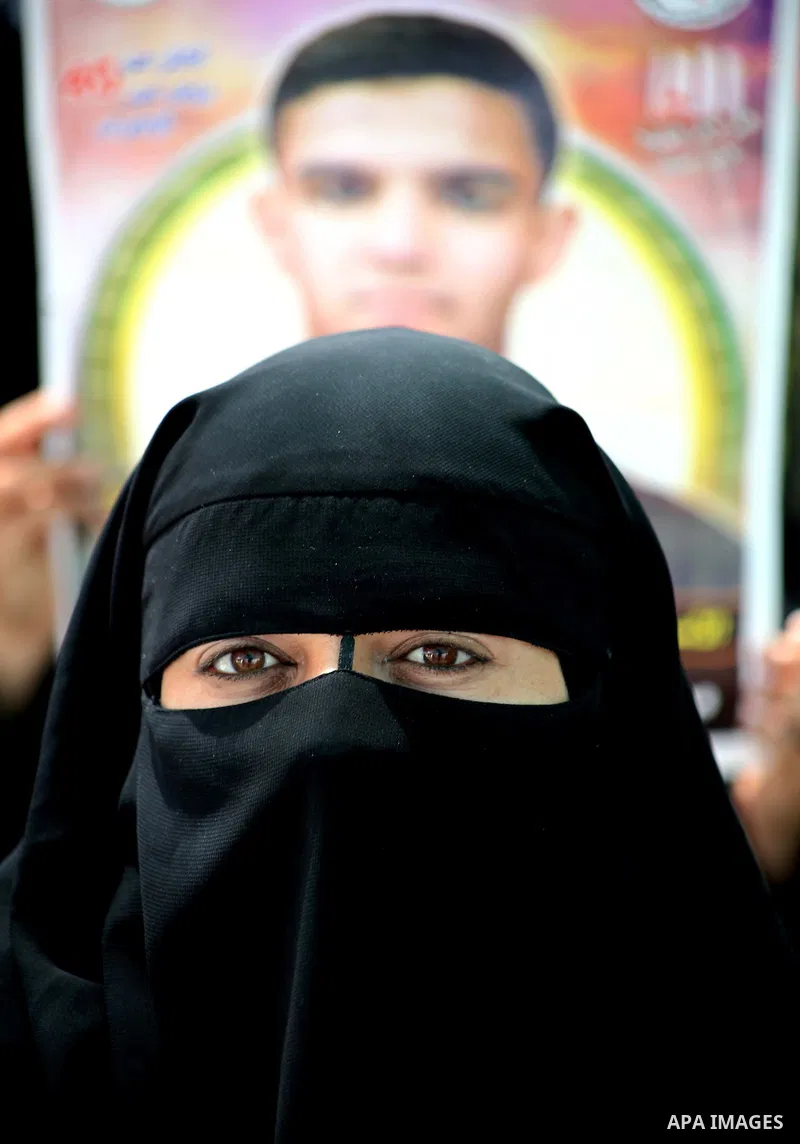 Palestinian women hold pictures of their jailed relatives during a sit-in in Gaza city in support of over 1,550 prisoners observing a hunger strike to demand better conditions in Israeli jails on May 12, 2012. The World...