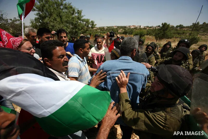 Palestinian protesters and foreign activists scuffle with Israeli soldiers during a demonstration ahead of "Nakba Day" in Beit Omar village, north of the West Bank town of Hebron, on May 12, 2012 where Israeli soldiers t...