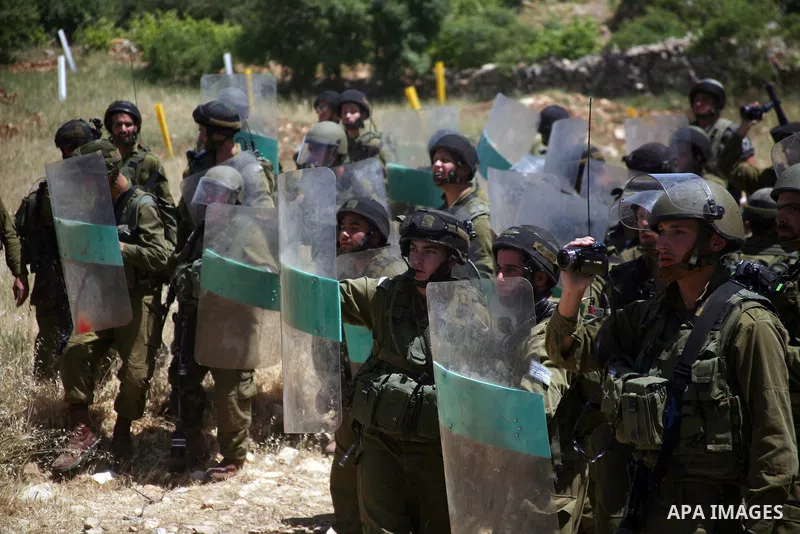 Israeli soldiers fire teargas canisters, during a demonstration ahead of "Nakba Day" in Beit Omar village, north of the West Bank town of Hebron, on May 12, 2012 where Israeli soldiers tried to evacuate demonstrators by...