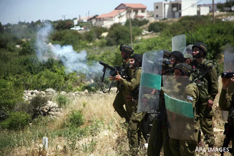 Israeli soldiers fire teargas canisters, during a demonstration ahead of "Nakba Day" in Beit Omar village, north of the West Bank town of Hebron, on May 12, 2012 where Israeli soldiers tried to evacuate demonstrators by...