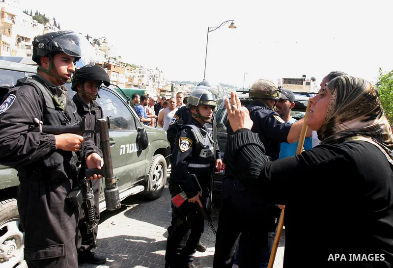 A Palestinian woman scuffle with Israeli police, after arresting a Palestinian during clashes between Palestinian youth and the Israeli police in the east Jerusalem neighbourhood of Silwan on May 12, 2012. Israel is to r...