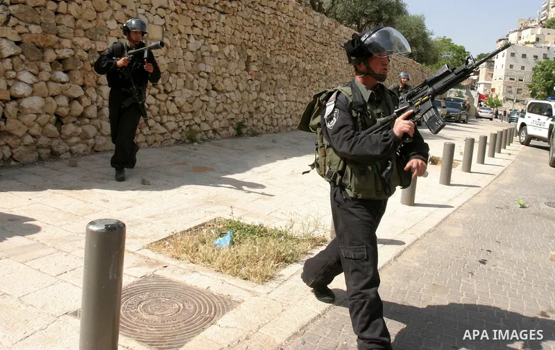 Israeli riot police fire teargas, before arresting a Palestinian during clashes between Palestinian youth and the Israeli police in the east Jerusalem neighbourhood of Silwan on May 12, 2012. Israel is to reply on May 12...
