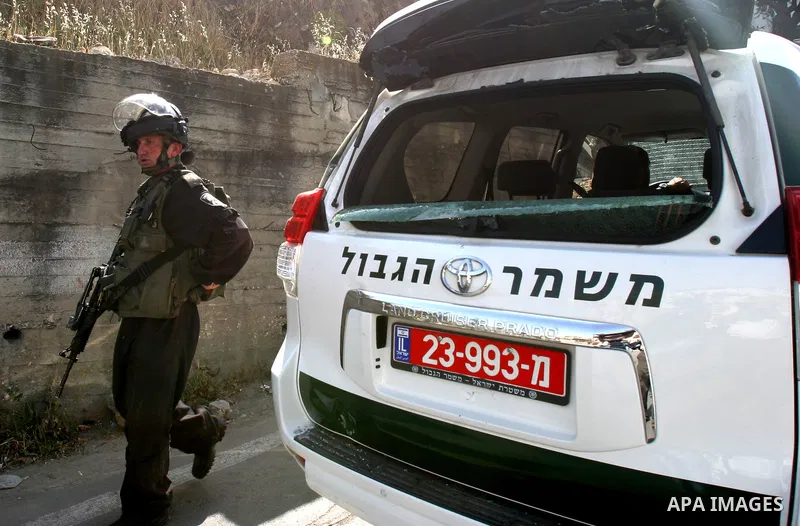 Israeli riot police get ready to arrest a Palestinian man in a car, whose rear window was smashed during clashes between Palestinian youth and the Israeli police in the east Jerusalem neighbourhood of Silwan on May 12, 2...