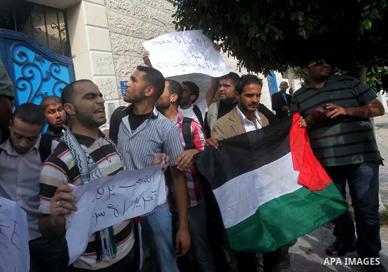 Palestinian men stand outside the headquarters of the International Committee of the Red Cross (ICRC) in Gaza as they forced the offices to close for two hours in solidarity with over 1,550 prisoners observing a hunger s...
