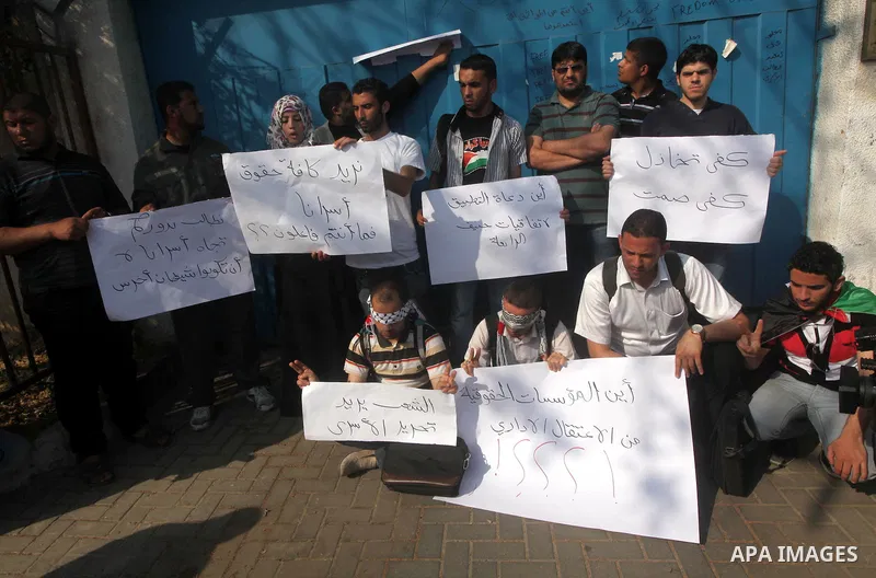 Palestinian men stand outside the headquarters of the International Committee of the Red Cross (ICRC) in Gaza as they forced the offices to close for two hours in solidarity with over 1,550 prisoners observing a hunger s...