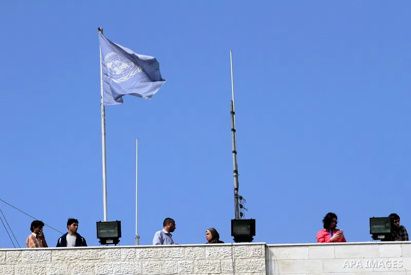 Palestinians stand above the headquarters of the International Committee of the Red Cross (ICRC) in Gaza as they forced the offices to close for two hours in solidarity with over 1,550 prisoners observing a hunger strike...