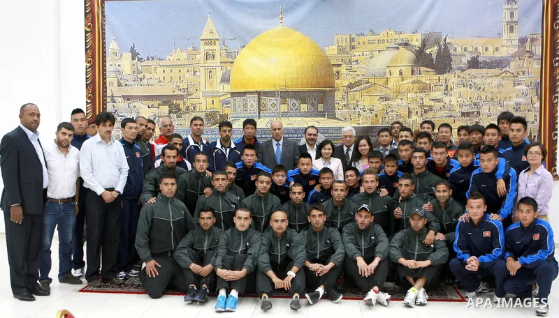 Palestinian President, Mahmoud Abbas (Abu Mazen) meets with Palestinian team and the Vietnamese national team participating in the tournament the Nakba, in the West Bank city of Ramallah, on May 14, 2012. Photo by Thaer...