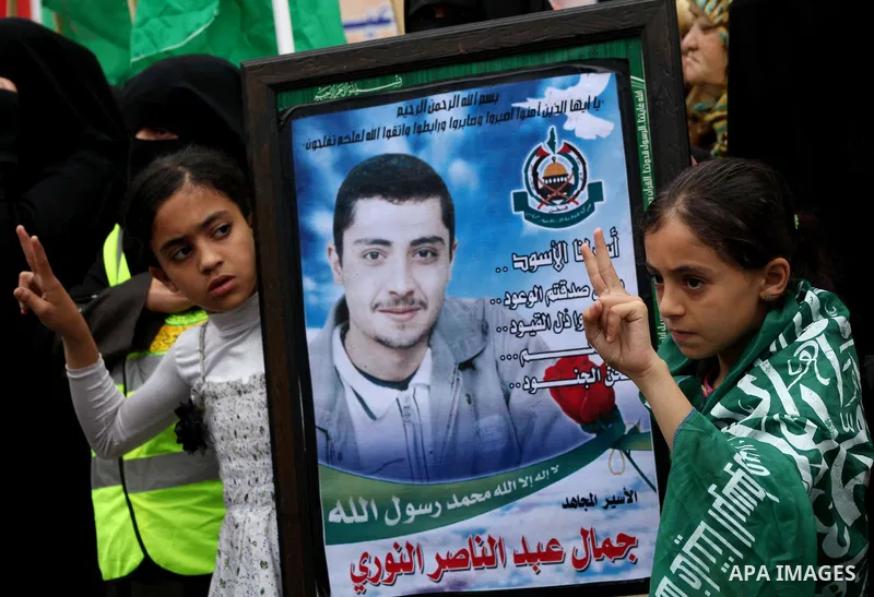 Palestinian children hold pictures of incarcerated relatives in a rally to show solidarity with prisoners held in Israeli jails, in Gaza City May 14, 2012. One in three of the 4,800 Palestinians serving time in Israeli j...