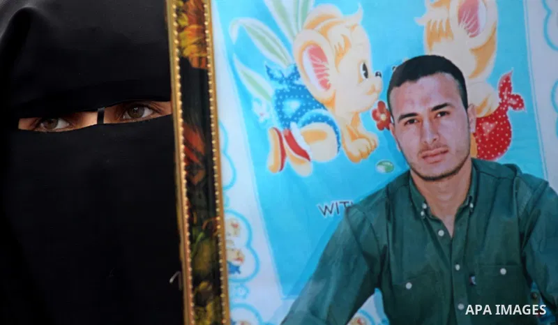 Palestinian women hold pictures of incarcerated relatives in a rally to show solidarity with prisoners held in Israeli jails, in Gaza City May 14, 2012. One in three of the 4,800 Palestinians serving time in Israeli jail...