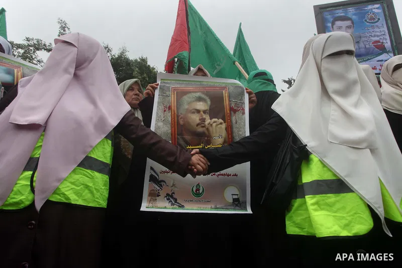 Palestinian women hold pictures of incarcerated relatives in a rally to show solidarity with prisoners held in Israeli jails, in Gaza City May 14, 2012. One in three of the 4,800 Palestinians serving time in Israeli jail...