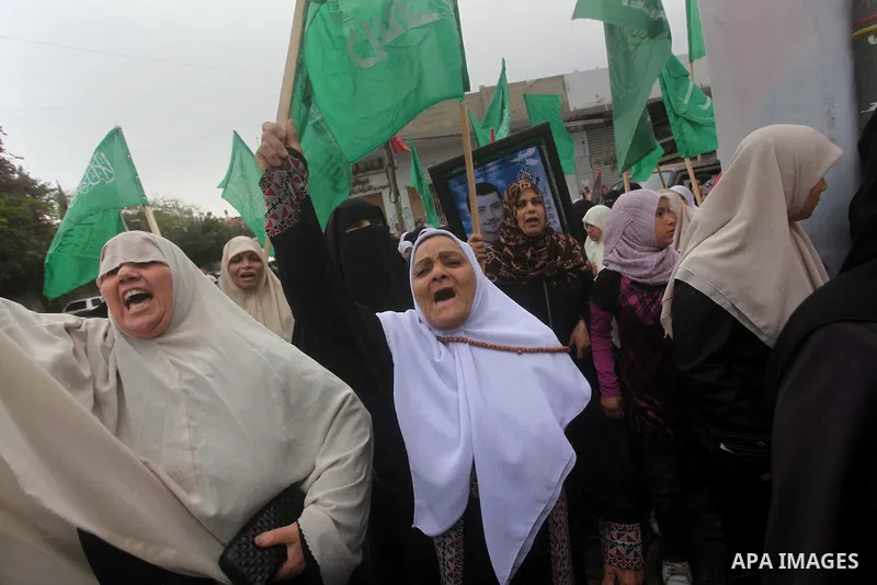 Palestinian women hold pictures of incarcerated relatives in a rally to show solidarity with prisoners held in Israeli jails, in Gaza City May 14, 2012. One in three of the 4,800 Palestinians serving time in Israeli jail...
