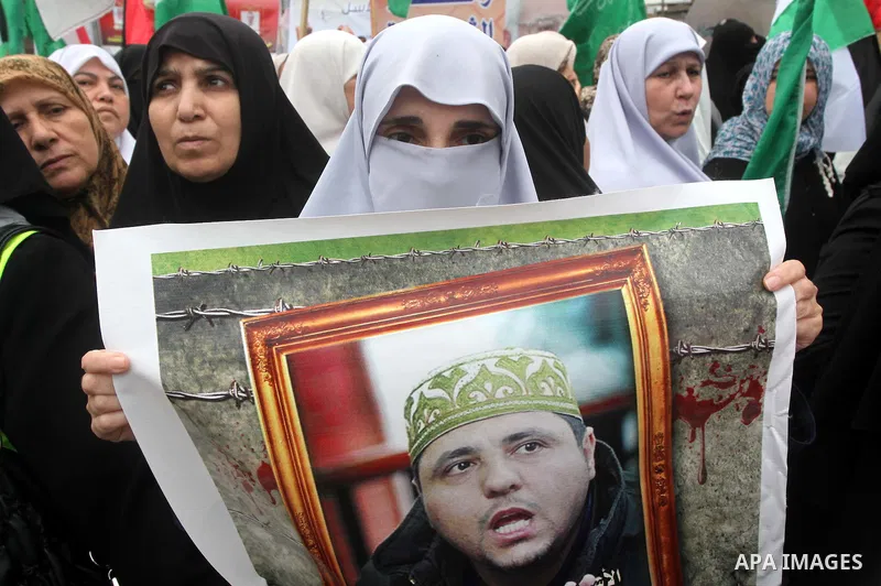 Palestinian women hold pictures of incarcerated relatives in a rally to show solidarity with prisoners held in Israeli jails, in Gaza City May 14, 2012. One in three of the 4,800 Palestinians serving time in Israeli jail...
