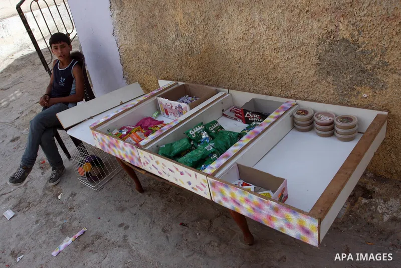 Palestinian child sell stuff for children, a day before Palestinians mark the 'Nakba' Day (Day of the catastrophe), in the Al Jalazoun refugee camp in the West Bank City of Ramallah on 14 May 2012. 'Nakba' Day for the Pa...