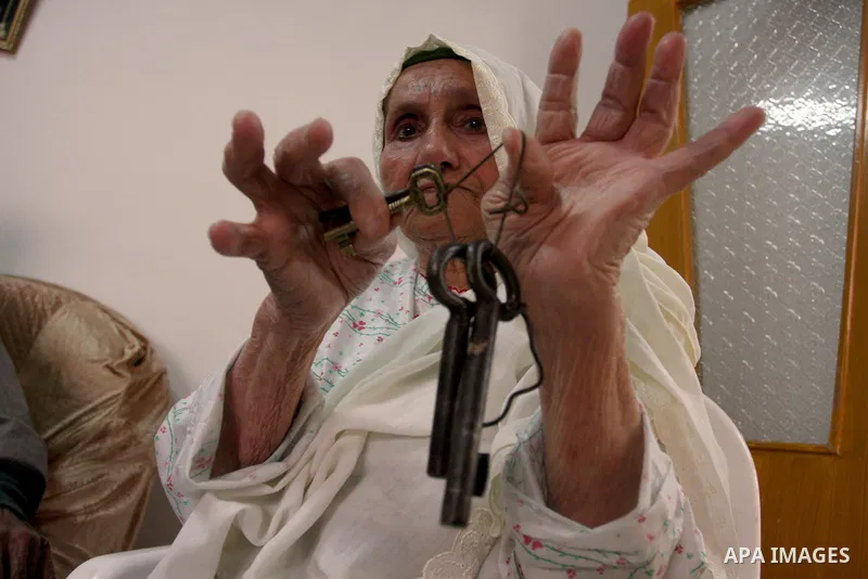A Palestinian refugee elderly woman Holds the keys, a day before Palestinians mark the 'Nakba' Day (Day of the catastrophe), in the Al Jalazoun refugee camp in the West Bank City of Ramallah on 14 May 2012. 'Nakba' Day f...