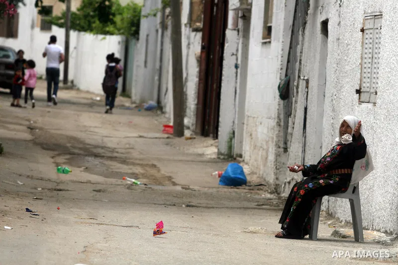 A Palestinian refugee elderly woman, set in front of her house, a day before Palestinians mark the 'Nakba' Day (Day of the catastrophe), in the Al Jalazoun refugee camp in the West Bank City of Ramallah on 14 May 2012. '...