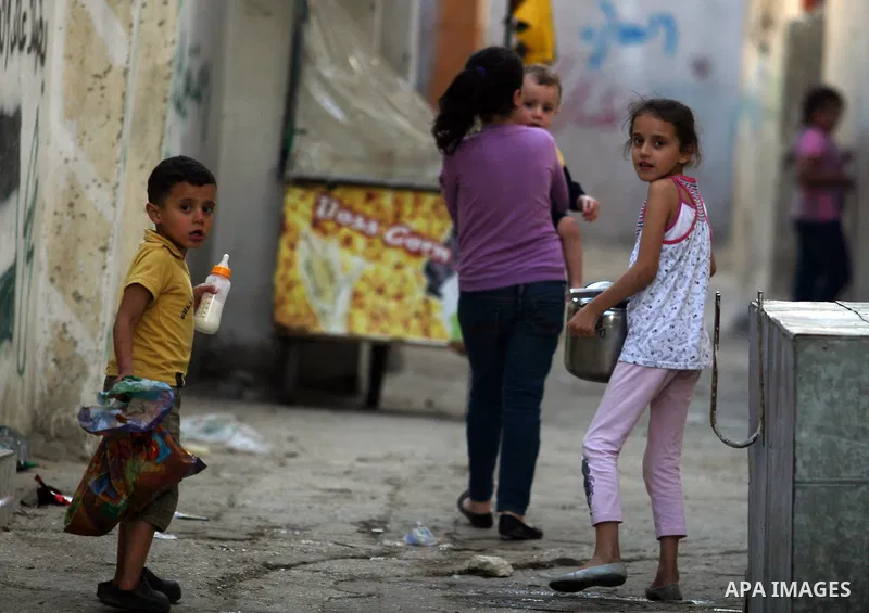Palestinian refugee children play outside their home, a day before Palestinians mark the 'Nakba' Day (Day of the catastrophe), in the Al amari refugee camp in the West Bank City of Ramallah on 14 May 2012. 'Nakba' Day fo...