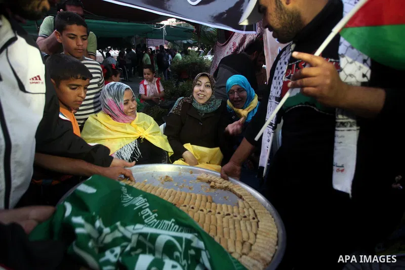Relatives of Palestinian prisoners held in Israeli jails celebrate after the signing of a deal to end the prisoners hunger strike in Gaza City on 14 May 2012. Israel and Palestinian signed an agreement 14 May ending a ma...