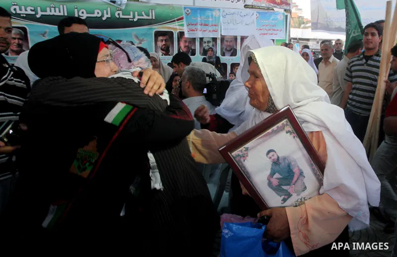 Relatives of Palestinian prisoners held in Israeli jails celebrate after the signing of a deal to end the prisoners hunger strike in Gaza City on 14 May 2012. Israel and Palestinian signed an agreement 14 May ending a ma...