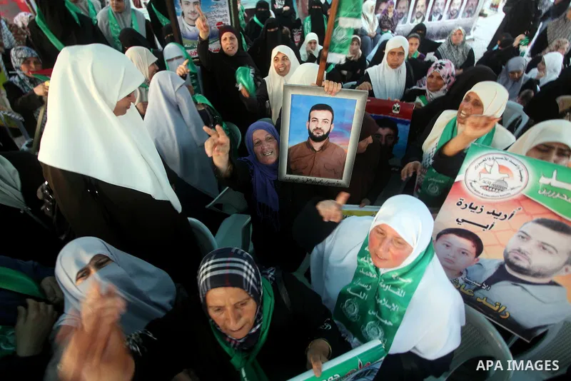 Relatives of Palestinian prisoners held in Israeli jails celebrate after the signing of a deal to end the prisoners hunger strike in Gaza City on 14 May 2012. Israel and Palestinian signed an agreement 14 May ending a ma...