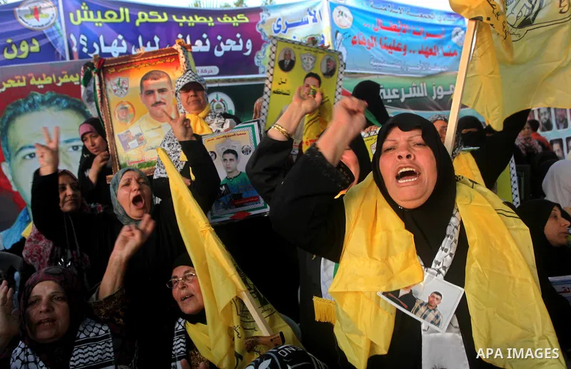 Relatives of Palestinian prisoners held in Israeli jails celebrate after the signing of a deal to end the prisoners hunger strike in Gaza City on 14 May 2012. Israel and Palestinian signed an agreement 14 May ending a ma...