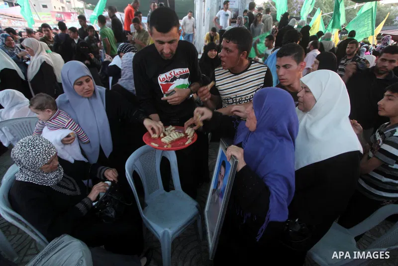 Relatives of Palestinian prisoners held in Israeli jails celebrate after the signing of a deal to end the prisoners hunger strike in Gaza City on 14 May 2012. Israel and Palestinian signed an agreement 14 May ending a ma...