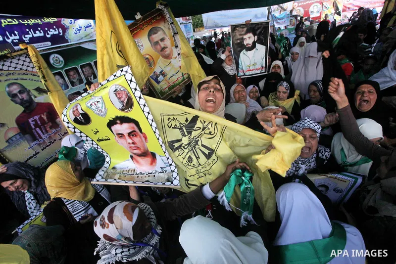 Relatives of Palestinian prisoners held in Israeli jails celebrate after the signing of a deal to end the prisoners hunger strike in Gaza City on 14 May 2012. Israel and Palestinian signed an agreement 14 May ending a ma...