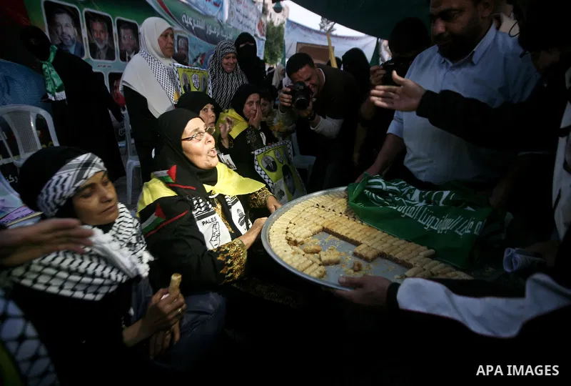 Relatives of Palestinian prisoners held in Israeli jails celebrate after the signing of a deal to end the prisoners hunger strike in Gaza City on 14 May 2012. Israel and Palestinian signed an agreement 14 May ending a ma...