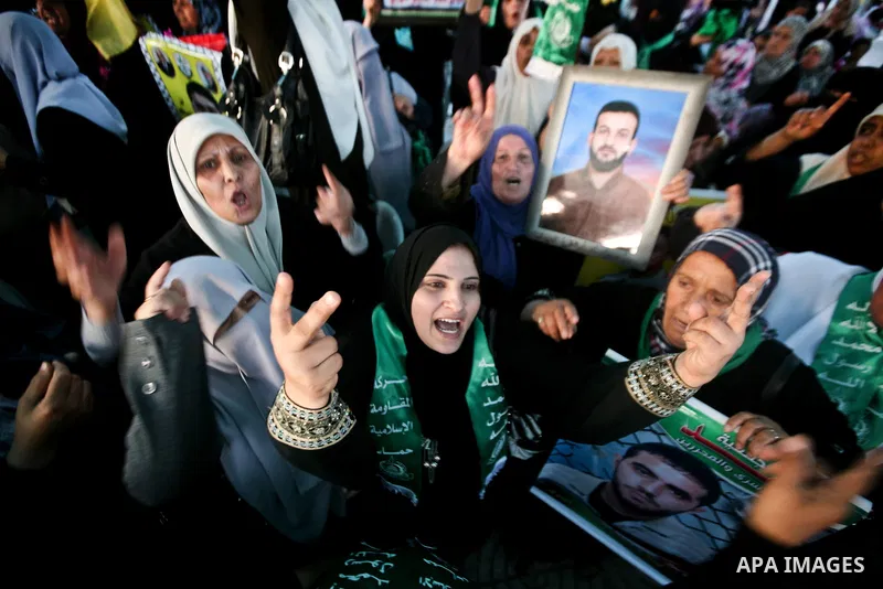 Relatives of Palestinian prisoners held in Israeli jails celebrate after the signing of a deal to end the prisoners hunger strike in Gaza City on 14 May 2012. Israel and Palestinian signed an agreement 14 May ending a ma...