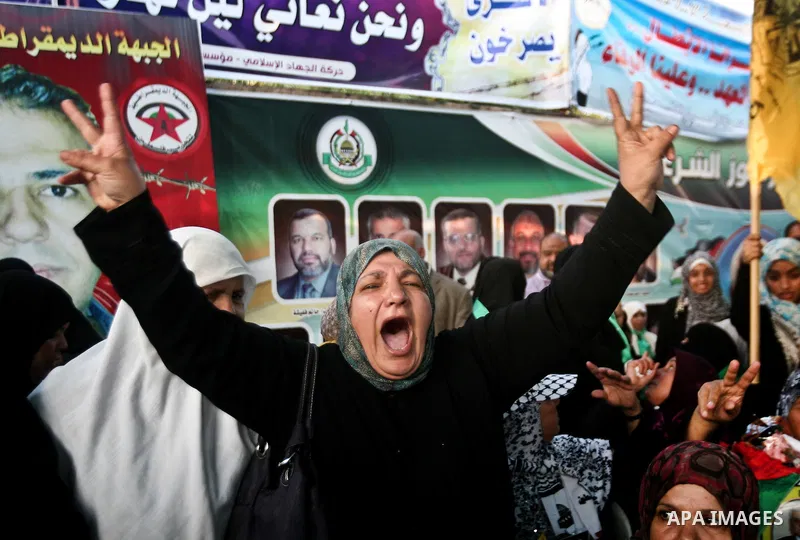 Relatives of Palestinian prisoners held in Israeli jails celebrate after the signing of a deal to end the prisoners hunger strike in Gaza City on 14 May 2012. Israel and Palestinian signed an agreement 14 May ending a ma...