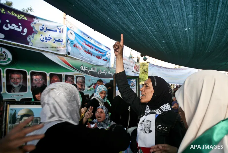 Relatives of Palestinian prisoners held in Israeli jails celebrate after the signing of a deal to end the prisoners hunger strike in Gaza City on 14 May 2012. Israel and Palestinian signed an agreement 14 May ending a ma...