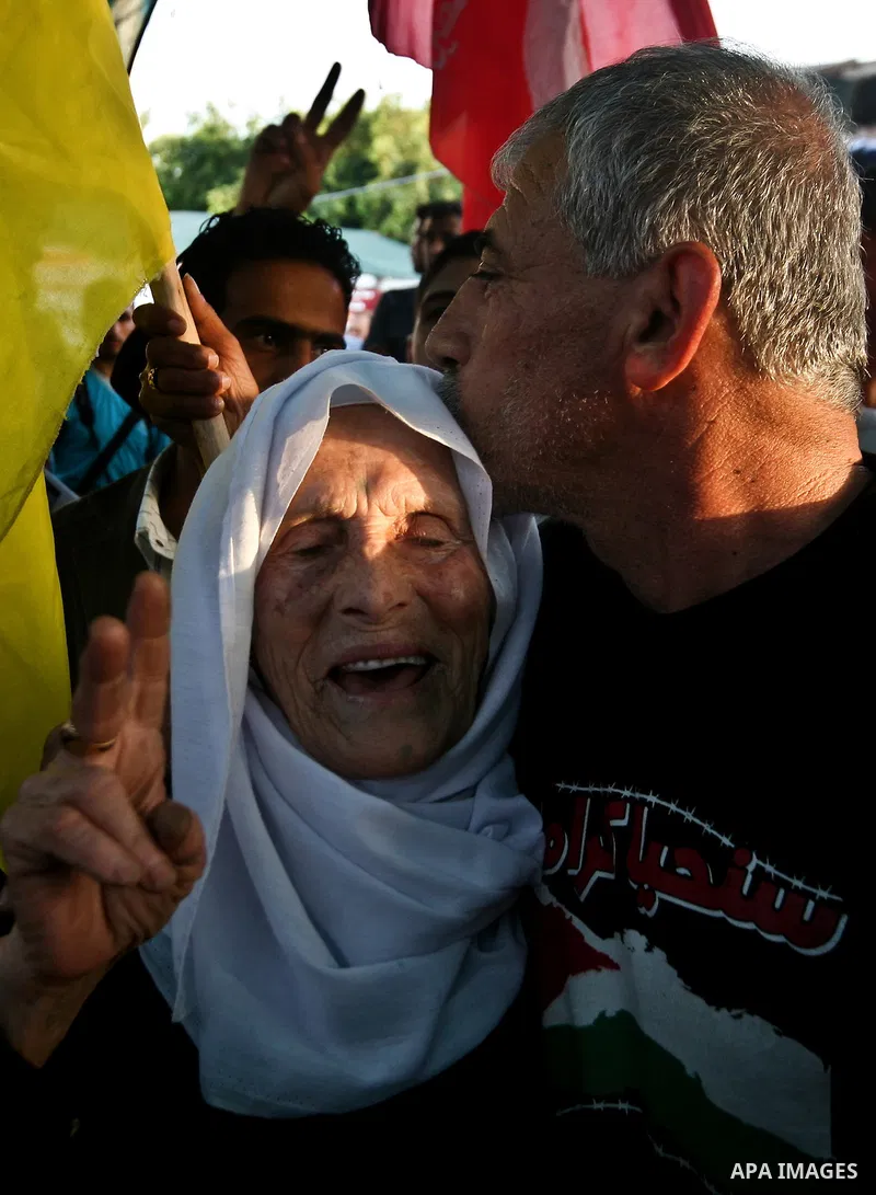 Relatives of Palestinian prisoners held in Israeli jails celebrate after the signing of a deal to end the prisoners hunger strike in Gaza City on 14 May 2012. Israel and Palestinian signed an agreement 14 May ending a ma...