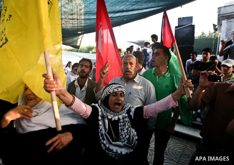Relatives of Palestinian prisoners held in Israeli jails celebrate after the signing of a deal to end the prisoners hunger strike in Gaza City on 14 May 2012. Israel and Palestinian signed an agreement 14 May ending a ma...