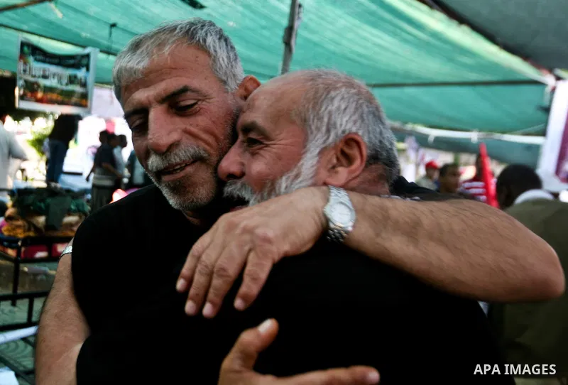Relatives of Palestinian prisoners held in Israeli jails celebrate after the signing of a deal to end the prisoners hunger strike in Gaza City on 14 May 2012. Israel and Palestinian signed an agreement 14 May ending a ma...