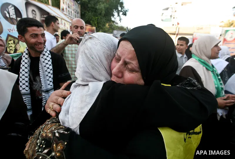 Relatives of Palestinian prisoners held in Israeli jails celebrate after the signing of a deal to end the prisoners hunger strike in Gaza City on 14 May 2012. Israel and Palestinian signed an agreement 14 May ending a ma...