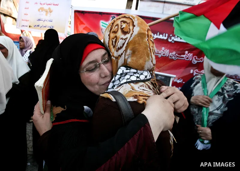 Relatives of Palestinian prisoners held in Israeli jails celebrate after the signing of a deal to end the prisoners hunger strike in Gaza City on 14 May 2012. Israel and Palestinian signed an agreement 14 May ending a ma...
