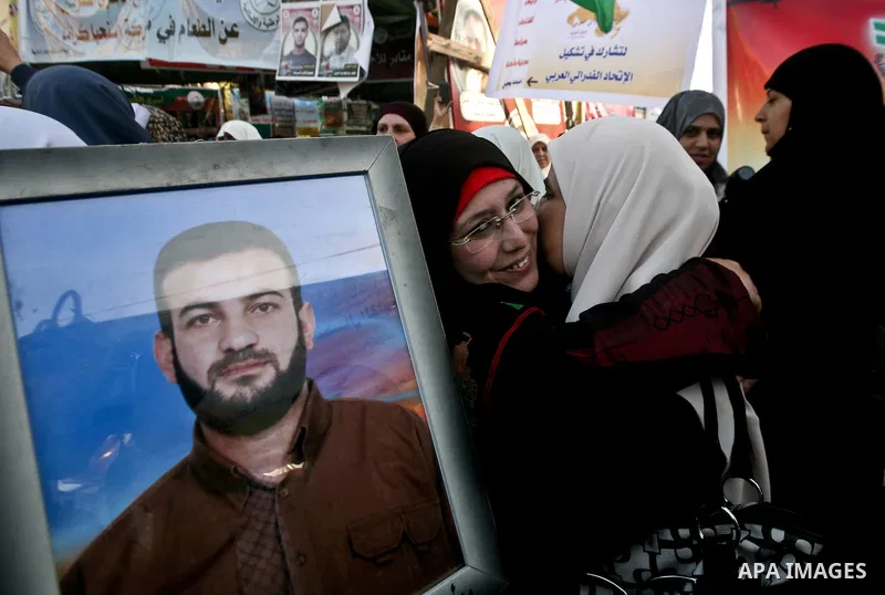 Relatives of Palestinian prisoners held in Israeli jails celebrate after the signing of a deal to end the prisoners hunger strike in Gaza City on 14 May 2012. Israel and Palestinian signed an agreement 14 May ending a ma...