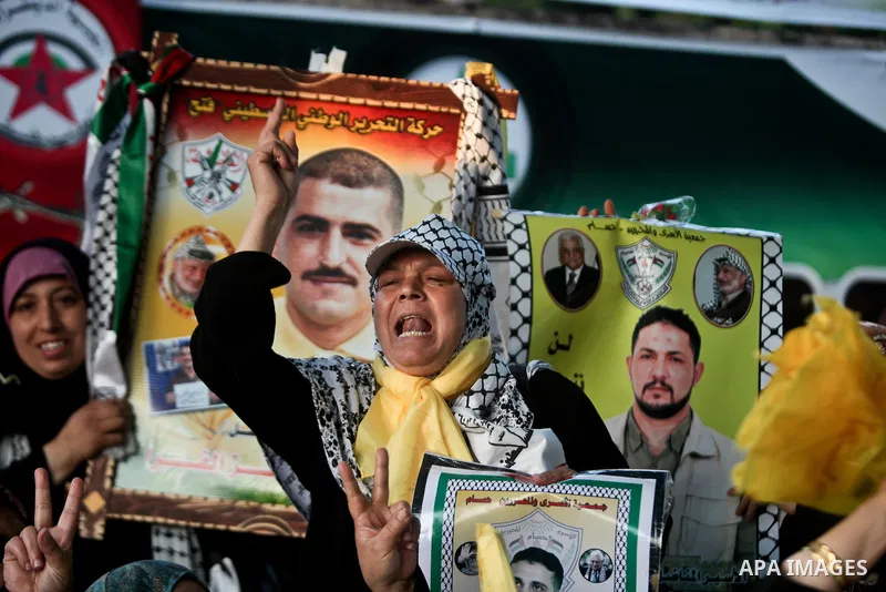 Relatives of Palestinian prisoners held in Israeli jails celebrate after the signing of a deal to end the prisoners hunger strike in Gaza City on 14 May 2012. Israel and Palestinian signed an agreement 14 May ending a ma...