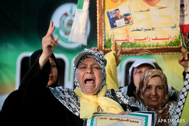 Relatives of Palestinian prisoners held in Israeli jails celebrate after the signing of a deal to end the prisoners hunger strike in Gaza City on 14 May 2012. Israel and Palestinian signed an agreement 14 May ending a ma...