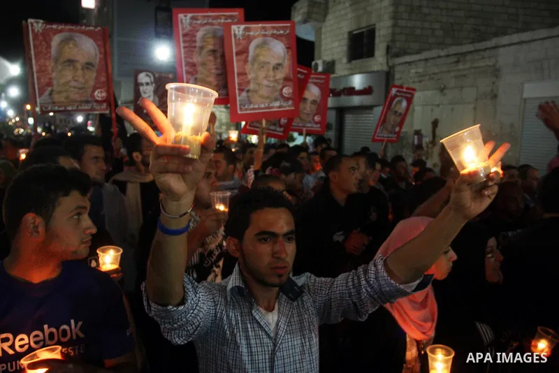 Palestinians hold pictures of prisoners and Palestinian flags as they celebrate the end of a prisoners' hunger strike in Israeli jails, in the West Bank city of Ramallah, Monday, May 14, 2012. Hundreds of Palestinian pri...