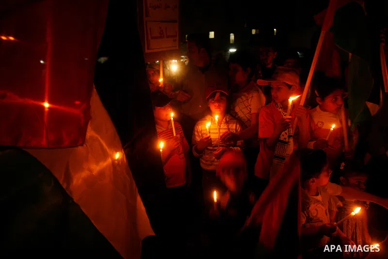 Palestinian children hold candles during a rally in Khan Younis in the southern Gaza Strip, ahead of Nakba May 14, 2012. On May 15 Palestinians will mark Nakba, or catastrophe, of Israel's founding in a 1948 war, when hu...