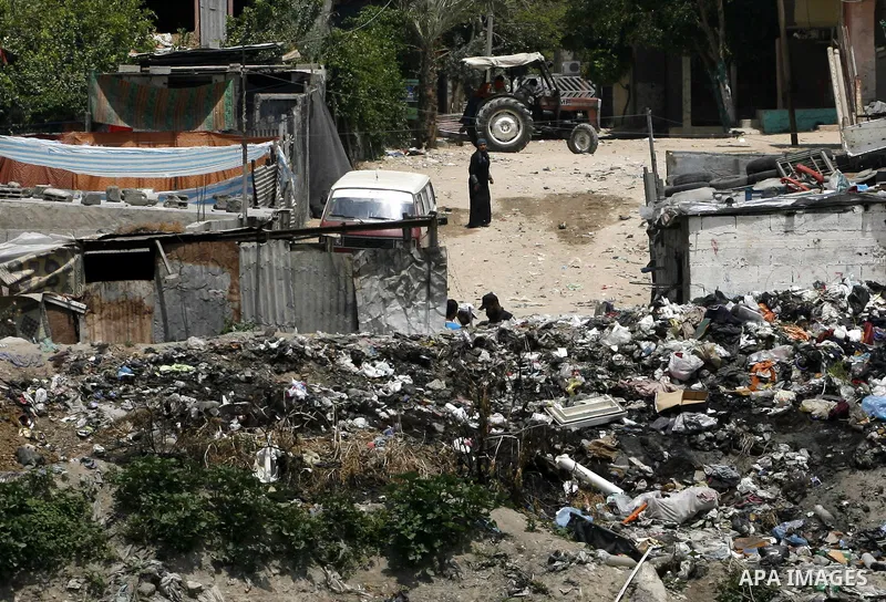 Palestinians stand among the garbage in the Rafah Refugee Camp in the southern Gaza Strip, ahead of Nakba Day. on May 15, 2012. 'Nakba' Day for the Palestinians is an annual day of commemoration of the displacement that...