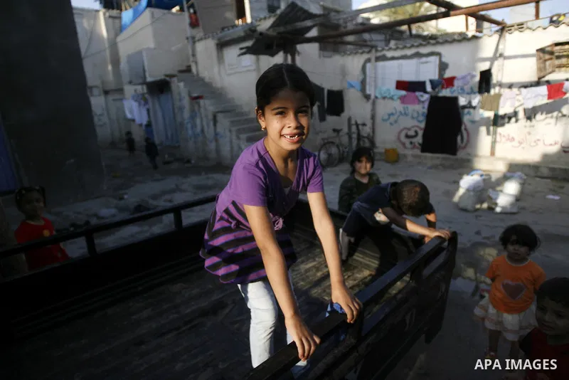Palestinian children play outside their home in the Rafah refugee camp in the southern Gaza Strip on May 13, 2012. 'Nakba' Day for the Palestinians is an annual day of commemoration of the displacement that followed the...