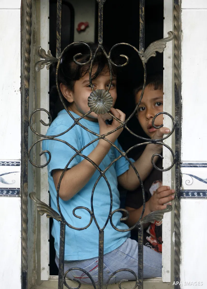 Palestinian children play outside their home in the Rafah refugee camp in the southern Gaza Strip on May 13, 2012. 'Nakba' Day for the Palestinians is an annual day of commemoration of the displacement that followed the...