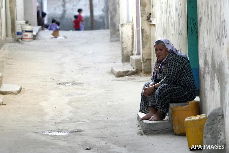 A Palestinian woman sits outside their home in the Rafah refugee camp in the southern Gaza Strip on May 13, 2012. 'Nakba' Day for the Palestinians is an annual day of commemoration of the displacement that followed the I...