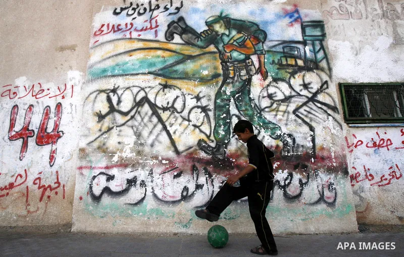 A Palestinian child plays outside their home in the Rafah refugee camp in the southern Gaza Strip on May 13, 2012. 'Nakba' Day for the Palestinians is an annual day of commemoration of the displacement that followed the...