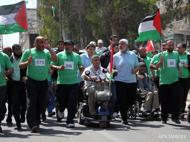 The head of Gaza's Hamas government, Ismail Haniya (blue polo shirt), takes part in a marathonin Gaza on May 15, 2012. 'Nakba' Day for the Palestinians is an annual day of commemoration of the displacement that followed...