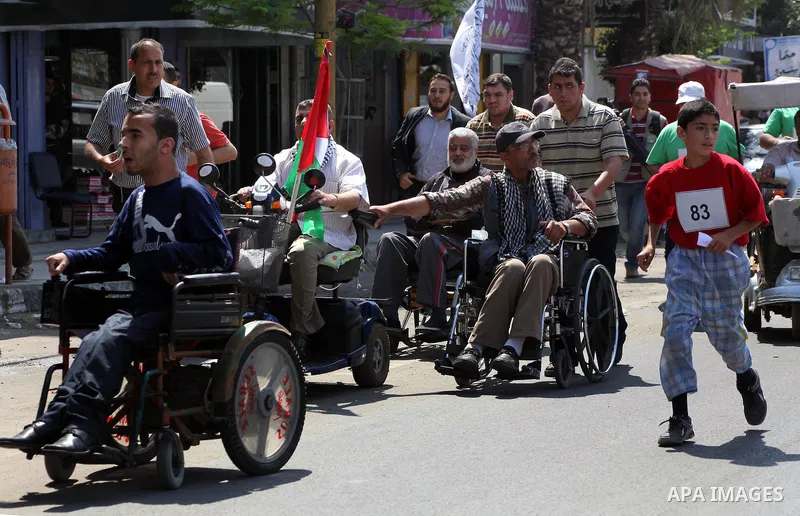 The head of Gaza's Hamas government, Ismail Haniya (not seen), takes part in a marathonin Gaza on May 15, 2012. 'Nakba' Day for the Palestinians is an annual day of commemoration of the displacement that followed the Isr...