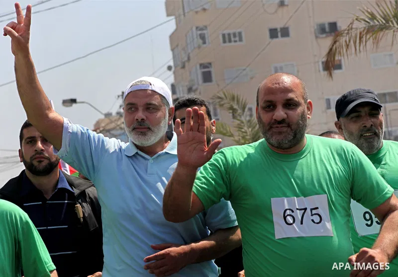 The head of Gaza's Hamas government, Ismail Haniya (blue polo shirt), takes part in a marathonin Gaza on May 15, 2012. 'Nakba' Day for the Palestinians is an annual day of commemoration of the displacement that followed...
